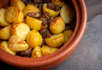 From traditional delicious Turkish food; potato and meat dish in casserole (Turkish name; Guvec tas kebabi, tandir)