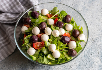 Purslane salad with cheese balls and olives inside. Healthy diet salad.