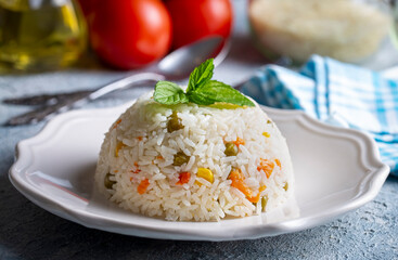 Delicious vegetable rice pilaf with green peas, carrots and sweet corn (Turkish name; sebzeli pilav)