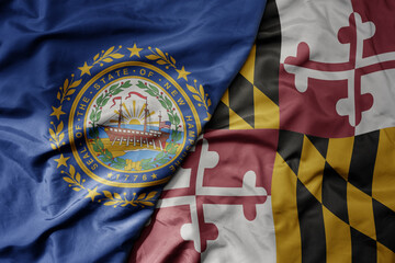 big waving colorful national flag of maryland state and flag of new hampshire state .
