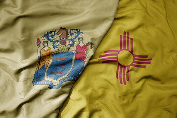 big waving colorful national flag of new mexico state and flag of new jersey state .