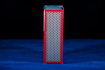 Side view of a box of matches. Red matchbox on a dark background