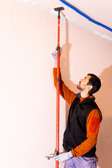 man installing a strut to support the roof in the renovation of a house