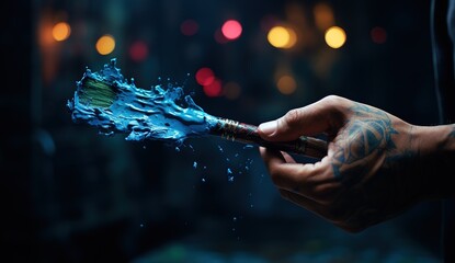The Art of Creation: Close-Up of an Artist’s Hand Holding a Paintbrush Dipped in Vibrant Colors