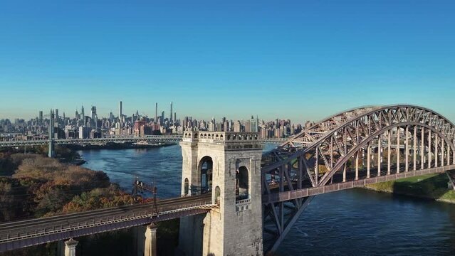 Aerial shot of New York City's Hell Gate Bridge on an autumn morning.