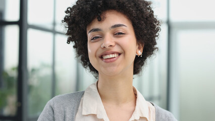 girl in the office smiles expresses success and leadership is thinking about success