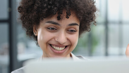 Portrait of Young Successful Caucasian Businesswoman Sitting at Desk Working on Laptop