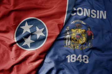 big waving colorful national flag of wisconsin state and flag of tennessee state .