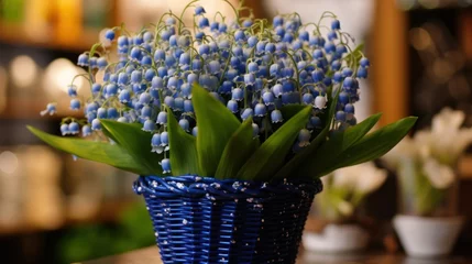 Rolgordijnen Lily of the valley in a wicker basket on a blurred background. Convallaria majalis. Springtime Concept. Mothers Day Concept with a Copy Space. Valentine's Day. © John Martin