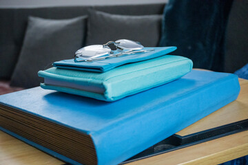 Blue Monday. A book, a notebook and a case with glasses, all in blue tones