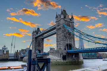 Iconic Tower Bridge connecting London with Southwark on the Thames River with a silhouette sunset sky