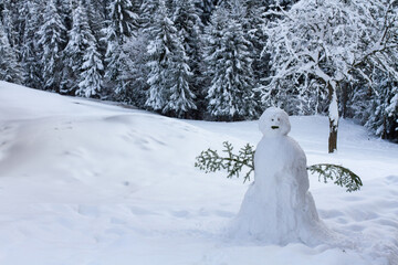 snowman in winter forest in Alps, sad weird snowman - obrazy, fototapety, plakaty