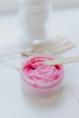 close-up of tools and materials with eyebrow paints in a beauty salon before the start of the procedure, on a white background brushes and cream