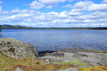 Land and water one summer day in July. Gray cliffs. Jämtland, Sweden.