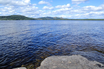 Land and water one summer day in July. Gray cliffs. Jämtland, Sweden.