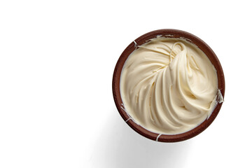 Butter whipped and twisted into a spiral in a brown clay bowl isolated on a background. Top view...