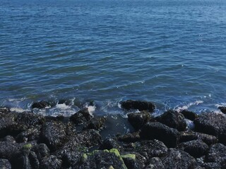 Rocky coastline of calm blue sea