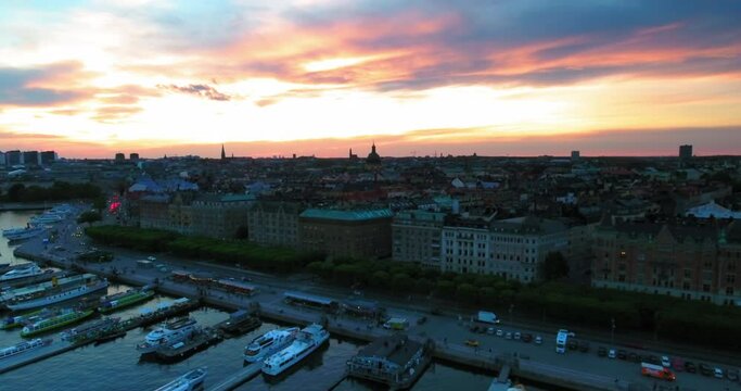 Aerial Shot Of Boats And Vehicles Near Buildings In City During Sunset - Stockholm, Sweden