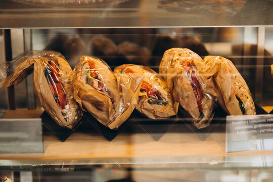 Showcase with sandwiches in the store. Small business, food concept. Lots of pastries in pastry shop