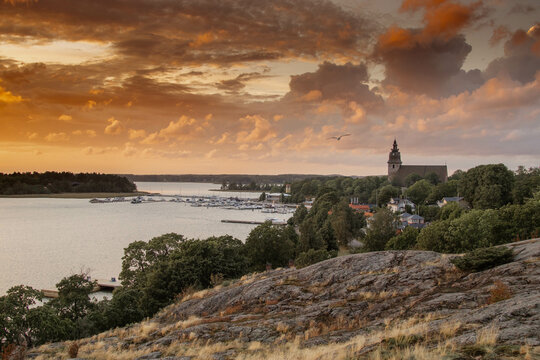 Dramatic colorful sunset in Naantali, Finland with the church and archipelago, sea and Moomin island