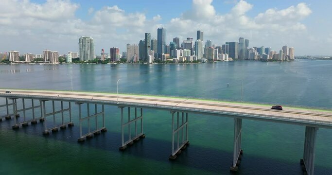 Miami Brickell in Florida, USA. William M Powell Bridge with moving traffic. Aerial view of American downtown office district. High commercial and residential skyscraper buildings