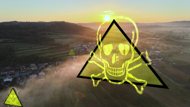 Aerial: Nuclear and radiation accident at nuclear power plant. Toxic smoke over the city ready for emergency evacuation. Death sign all over the toxic area