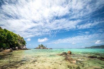 View of nice tropical beach with palms and granite rocks. Holiday and vacation concept. Tropical beach. Mahe Island, Seychelles. Anse Roayle