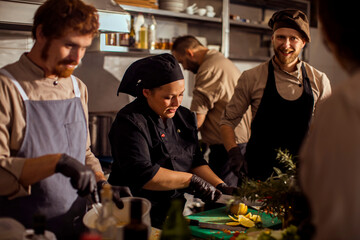 Professional chefs preparing meal in the kitchen at restaurant