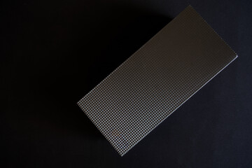 Dark paper rectangular box with an embossed lid on a black background. Diagonal. Minimalism. Photo....