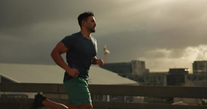 Running, fitness and man in city for exercise, marathon training and cardio workout in morning. Sports, runner and person in road for performance, endurance and wellness for competition or race