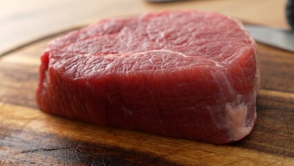 Fresh Raw Steak on Wooden Board.