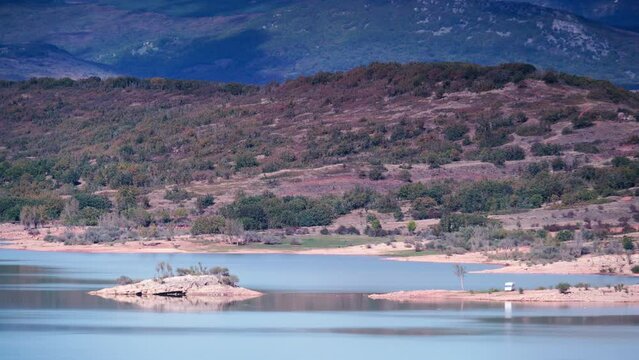 Caravan on lake shore, embalse de Aguilar de Campoo in province of Palencia, Castile and Leon community, northern Spain.