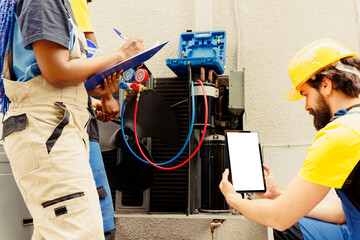 Skilled expert cleaning and lubricating outside hvac system internal evaporator coil, checking...