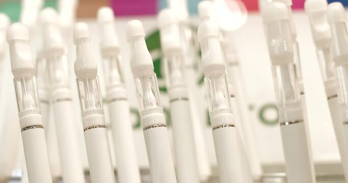 Close-up of vape pen is a portable vaping device at international trade show. These devices are designed to vaporize liquid. An alternative to tobacco smoking. 