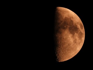 Closeup of a quarter moon against a black sky