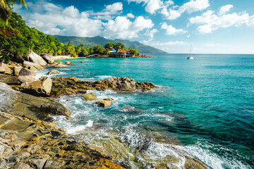 Tropical landscape with palm trees and granite rocks. Sunset beach at Seychelles, Mahe