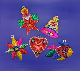 Mexican tin christmas decorations on blue background