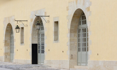 Fototapeta na wymiar Row of three arched doorways with doors