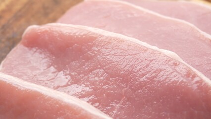 Dolly shot of Sliced Pork Loin on Wooden Board.