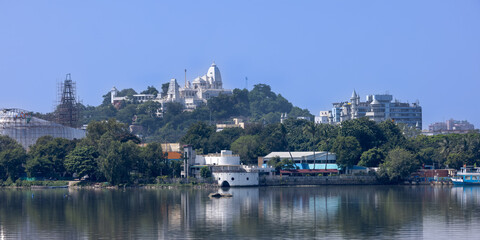 Panoramic view of Hyderabad cityscape in India, Marble stone Birla temple and reflection in Hussain Sagar lake.