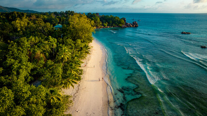 Aerial view Top down seashore. Beautiful azure sea surface in sunny day summer background Amazing seascape top view seacoast at Anse Severe Beach, La Digue Seychelles © Alexey Oblov