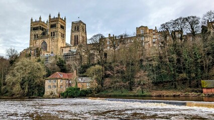 Beautiful view of the river Wear and the historic Durham Cathedral surrounded by trees in England
