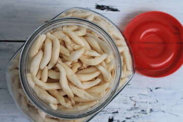 Indonesian snack called telur gabus in a jar on the table