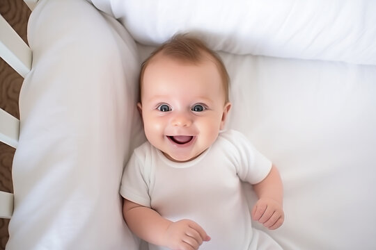 A five-month-old baby boy lies in a crib and laughs. Happy healthy child smiling