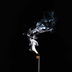 Smoking Match Stick on a Black Background