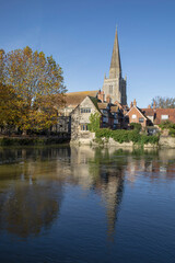 A view across the river at Abingdon on Thames. Across the river is the spire of St Helens church is reflected in the water - 678918425