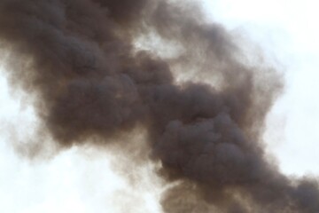 Thick black smoke from a massive burning fire