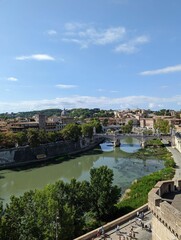 Fototapeta premium Beautiful landscape of an old bridge over the river in ancient Rome, Italy