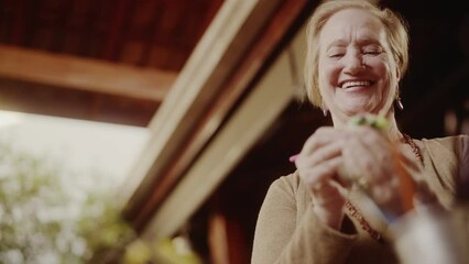 Happy middle-aged woman relax at home doing her favorite hobby activity. Cinematic 4k.