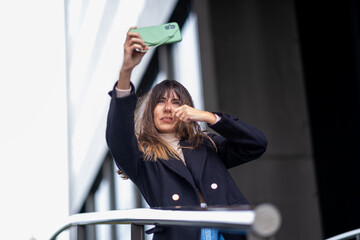 Playful outdoor selfies in windy weather.